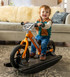 A baby laughing and playing on the Orange Rush 2-in-1 Rocking Bike