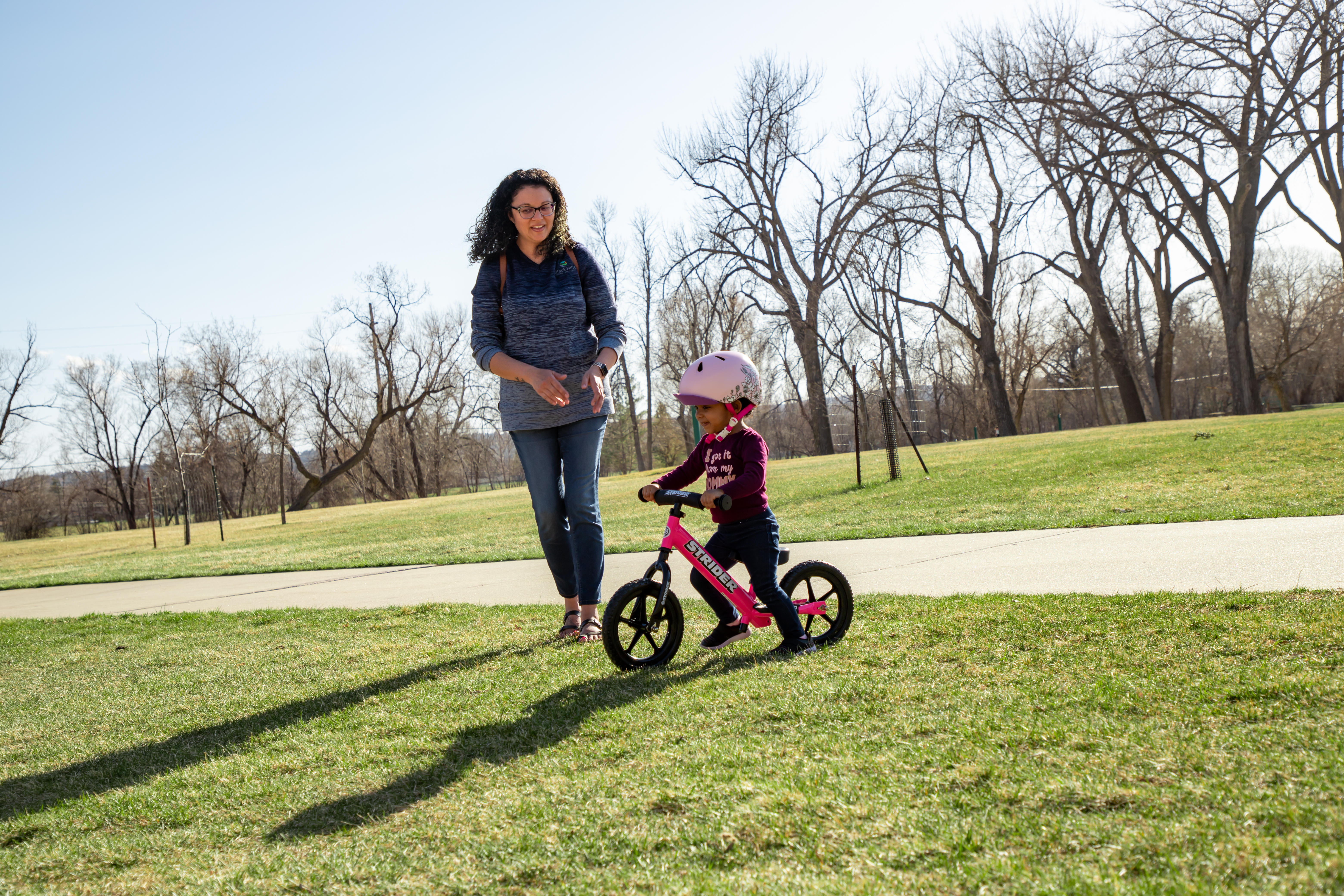 How do I teach my toddler to ride their balance bike?