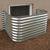 Galvanized steel window well installed against a basement foundation wall
