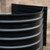 Close-up of the gloss black powder coated corrugated steel and reinforced top safety lip
