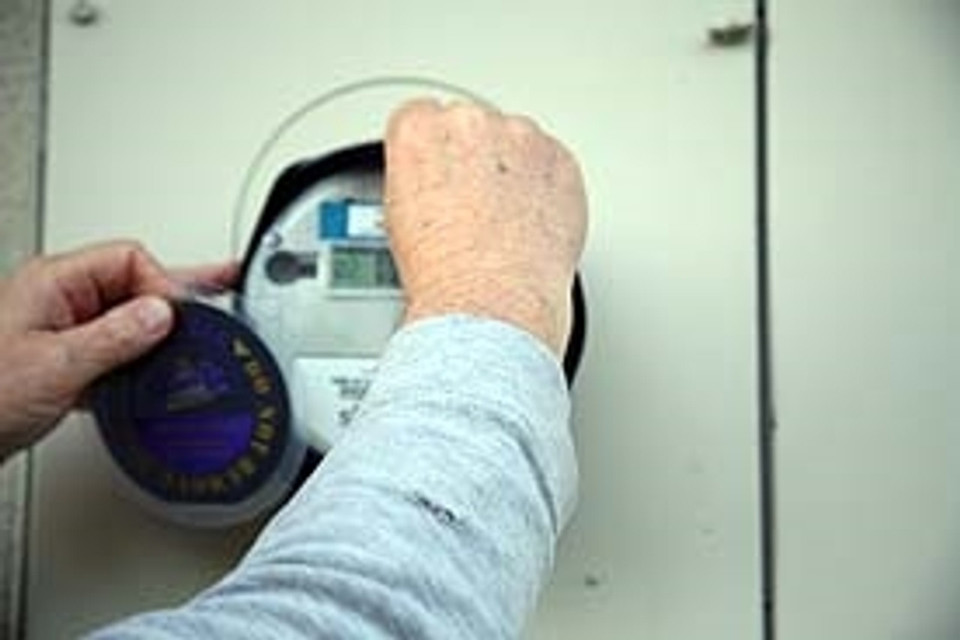 Slide the second of the two Tachyon disks under the EverStay band on the bottom of the meter. Make sure the text, “Energy flows out this side” is facing the center of the meter to fully protect your family from Smart Meter EMF radiation.