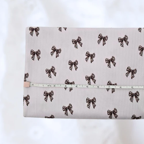 Leopard Bow Off White Poly Rib Knit Fabric (sold by half yards)