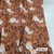 Beth's Exclusive Cream Florals on Rust Orange Poly Rib Knit Fabric (sold by half yards) Beth's Exclusive Cream Florals on Rust Orange Poly Rib Knit Fabric (sold by half yards)