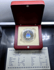 Polished silver holographic coin commemorating the 60th anniversary of His Majesty's accession to the throne, with wooden box and certificate, 2006.