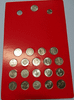 A complete set of 22 uncirculated 1-baht commemorative coins and a 1-baht banknote (King Rama IX), packaged in a red blister pack.