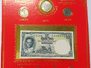 A complete set of 22 uncirculated 1-baht commemorative coins and a 1-baht banknote (King Rama IX), packaged in a red blister pack.