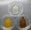 A set of three commemorative coins (silver, brass, copper) for the 5th cycle birthday anniversary of King Rama IX in 1987. Rare. Comes with a box.