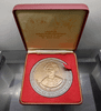 A commemorative coin for Her Majesty Queen Sri Savangavadhana's 90th birthday, made of blackened copper, 7 cm in diameter, minted in 1990 (B.E. 2533), with original box.