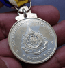 Silver commemorative coin decorated with ribbon, celebrating the 72nd birthday anniversary of King Rama IX, 1999, "Male style"