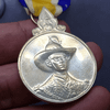 Silver commemorative coin decorated with ribbon, celebrating the 72nd birthday anniversary of King Rama IX, 1999, "Male style"