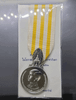 A commemorative medal decorated with a ribbon, in honor of the coronation ceremony of King Rama X, male style.