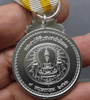 A commemorative medal decorated with a ribbon, in honor of the coronation ceremony of King Rama X, male style.