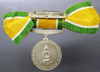 Medallion decorated with ribbon, King Rama IX, commemorating the 25th anniversary of the accession to the throne, 1971, silver (female model)