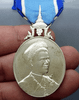 A commemorative medal decorated with a ribbon, celebrating the 60th birthday anniversary of Her Majesty Queen Sirikit, 2004, "Male Model"