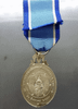 A commemorative medal decorated with a ribbon, celebrating the 60th birthday anniversary of Her Majesty Queen Sirikit, 2004, "Male Model"
