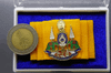 Golden Jubilee pin on yellow silk cloth, created on the occasion of the 75th birthday of King Rama IX in 2002, with original case, guaranteed authentic.