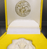 A polished silver coin of the King sitting on the throne, commemorating the 50th anniversary of the King's accession to the throne, created by the Ministry of Interior in 1996, with original box.