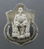 A polished silver coin of the King sitting on the throne, commemorating the 50th anniversary of the King's accession to the throne, created by the Ministry of Interior in 1996, with original box.