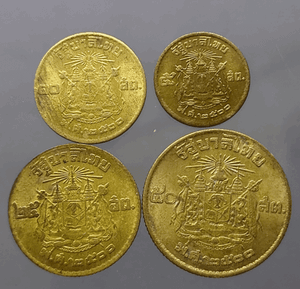 A complete set of four circulating brass coins (5, 10, 25, and 50 satang), minted in 1957 (B.E. 2500), showing signs of use.