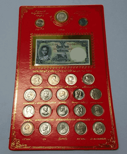A complete set of 22 uncirculated 1-baht commemorative coins and a 1-baht banknote (King Rama IX), packaged in a red blister pack.