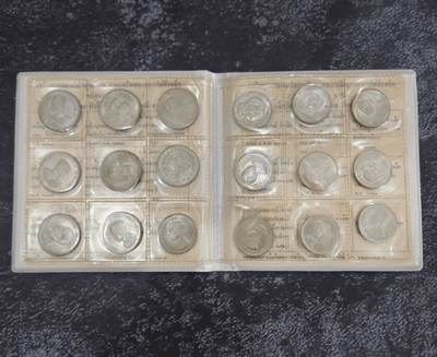 Complete set of 18 1-baht coin albums, leather-bound, from the Royal Thai Mint. Uncirculated (limited production).