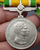 Medallion decorated with ribbon, King Rama IX, commemorating the 25th anniversary of the accession to the throne, 1971, silver (female model)