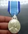 A commemorative medal decorated with a ribbon, celebrating the 60th birthday anniversary of Her Majesty Queen Sirikit, 2004, "Male Model"