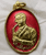 Auspicious musical medal with the royal inscription "The King plays music" on the back, made of gold-plated brass with red enamel, celebrating the 21st anniversary of the Music Association of Thailand, 1987.