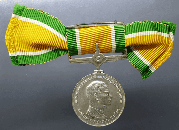 Medallion decorated with ribbon, King Rama IX, commemorating the 25th anniversary of the accession to the throne, 1971, silver (female model)