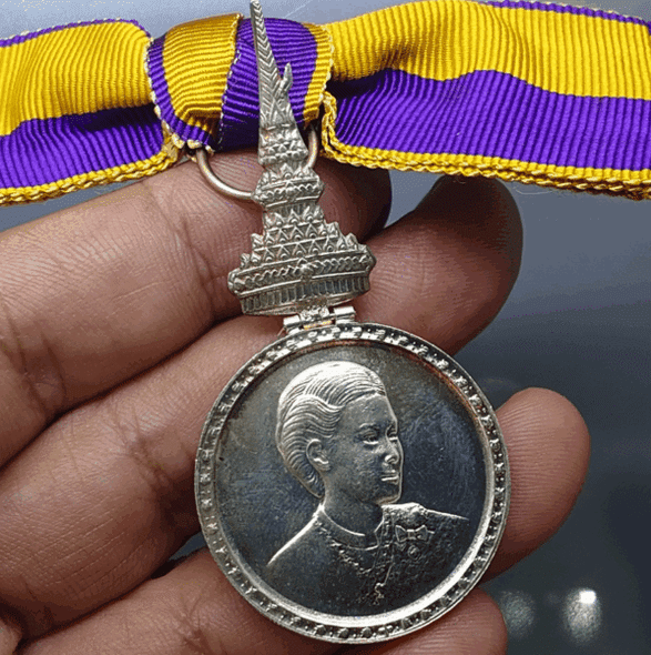 A commemorative medal decorated with a ribbon, the Royal Ceremony of the Coronation of Her Royal Highness Princess Maha Chakri Sirindhorn, 1977, "Female Model"