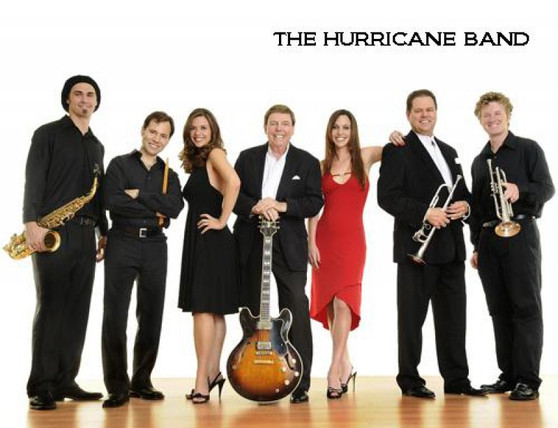 "The Hurricane Band rocking the stage with high-energy music at a wedding reception"