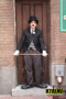 "Charlie Chaplin impersonator entertaining guests with silent comedy at a vintage-themed event"
