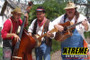 "The Sweeney Family Band performing live at a community event with guitars and drums"