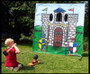 "Players storming a medieval-style inflatable castle game at a festival"