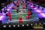 "Interactive 8-person LED foosball table lit up for nighttime outdoor event"