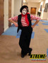"Professional mime performer entertaining guests at a corporate event with silent comedy"