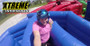 "Dizzy X inflatable obstacle course with participants navigating spinning challenges"