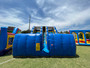 "Blue and yellow dual lane slide for kids at an outdoor event"