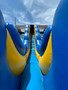 "Blue and yellow dual lane slide for kids at an outdoor event" "Blue and yellow dual lane slide for kids at an outdoor event"