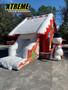 "Snowman house combo with a slide for kids at a holiday event"