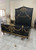 FACTORY PHOTO OF BLACK AND GOLD BED WITH HIGH HEADBOARD