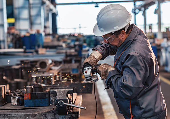 Metal Worker Performaing Task Wearing PPE