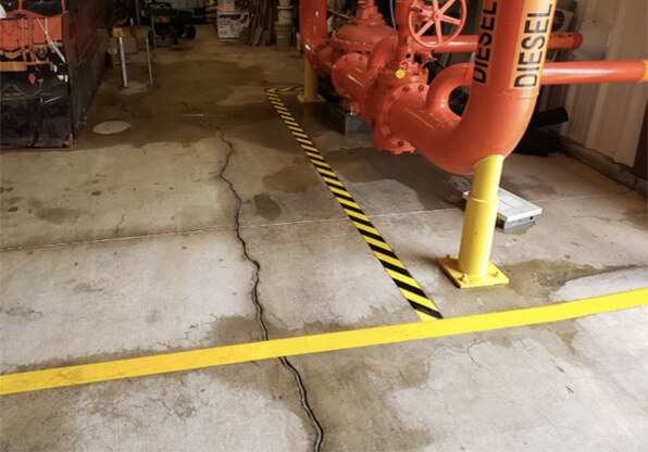 Pipe Markers Next to Floor Marking Tape