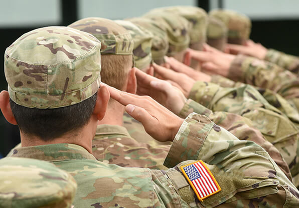 soldiers stand and salute