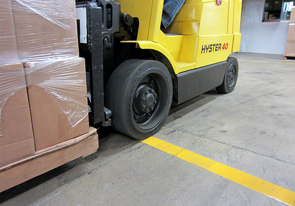Forklift Driving Over Floor Tape