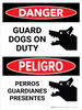 Danger: Guard Dogs On Duty Bilingual Spanish Portrait - Wall Sign