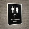 Restrooms With Up Arrow Black Bilingual Spanish Portrait - Wall Sign