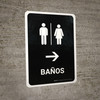 Restrooms With Right Arrow Black Spanish Portrait - Wall Sign