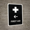 First Aid With Left Arrow Black Portrait - Wall Sign
