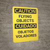 Caution: Flying Objects Bilingual Spanish - Wall Sign